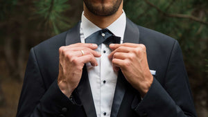 Male model wearing a black bow brooch